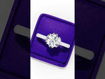 Load and play video in Gallery viewer, Round Cut Moissanite Engagement Ring | Six Prong Solitaire with Hidden Diamond Accents
